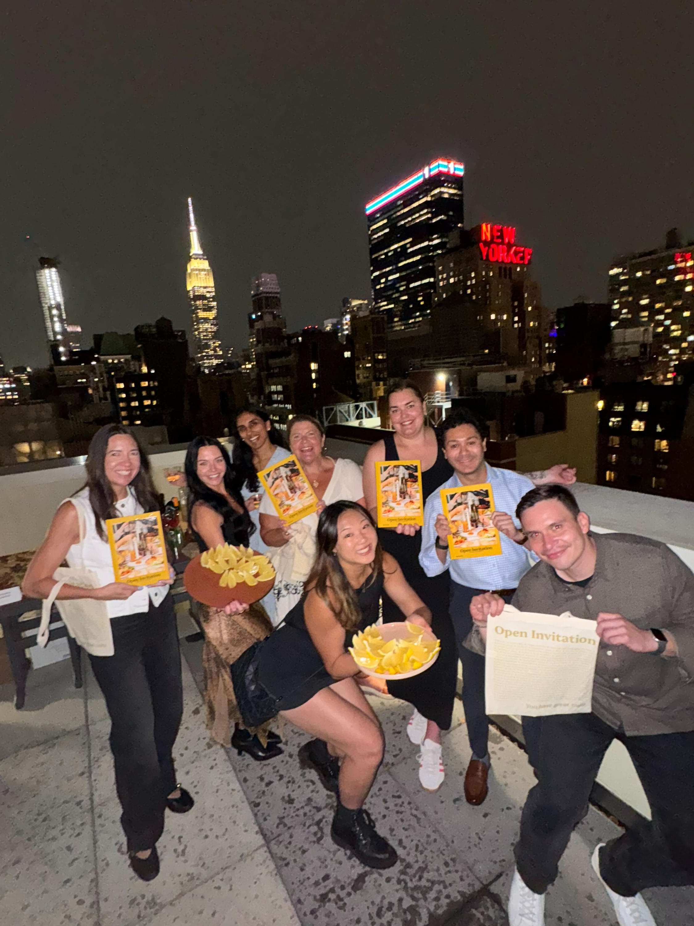 Group of people on a rooftop with city skyline in the background